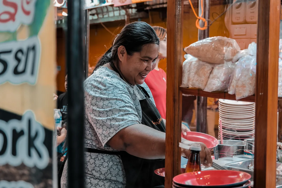 A food-business owner stands outside his street-side shop in a local neighbourhood.